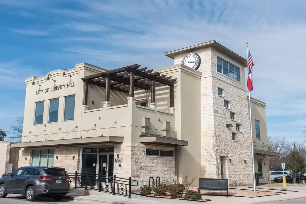 City of Liberty Hill municipal building with a clock tower and flag in downtown Liberty Hill, Texas